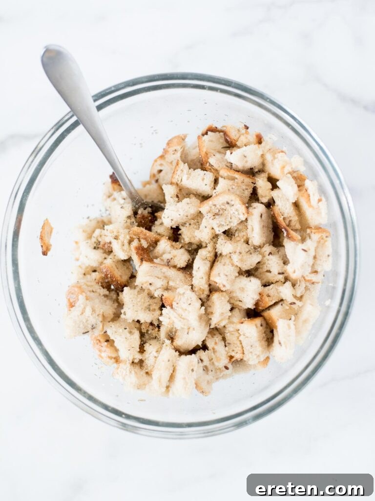 Bread in a mixing bowl with seasoning