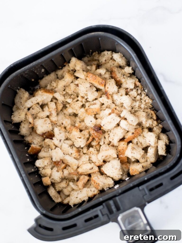 Seasoned bread in the air fryer basket, ready to cook