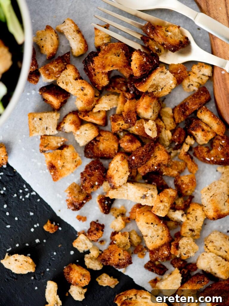 Homemade Croutons in the Air Fryer on parchment paper, ready to be served