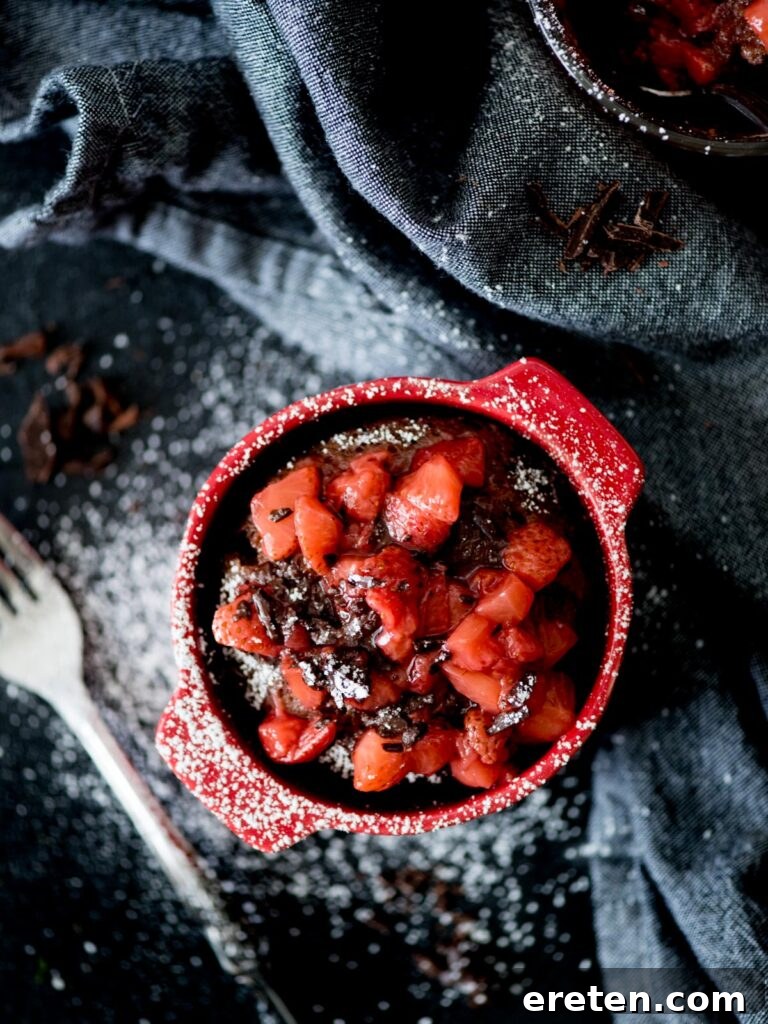 Chocolate Mug Cake with Sweet Strawberry Topping and powdered sugar