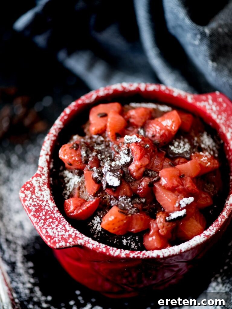 Chocolate Mug Cake with Sweet Strawberry Topping and powdered sugar