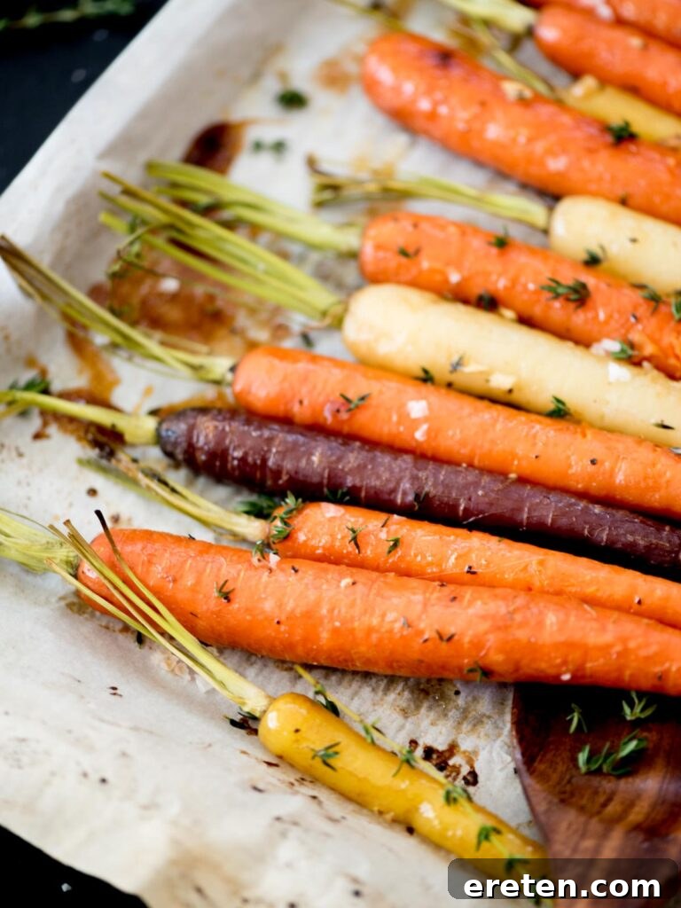 Golden Brown Sugar Glazed Carrots 8 Close-up of perfectly roasted brown sugar garlic carrots with fresh thyme garnish.