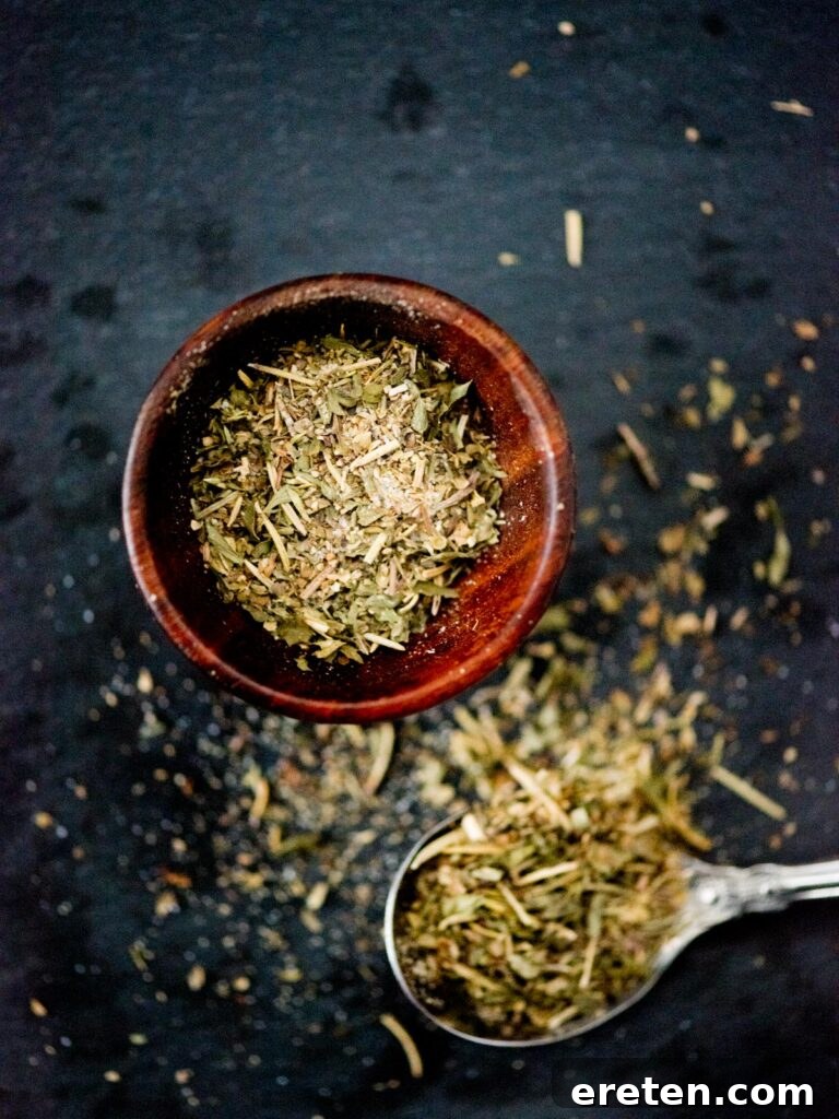 Homemade Greek seasoning blend in a small pinch bowl with a spoon