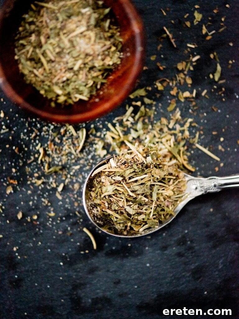Dried Greek herb seasoning in a spoon, ready to be used