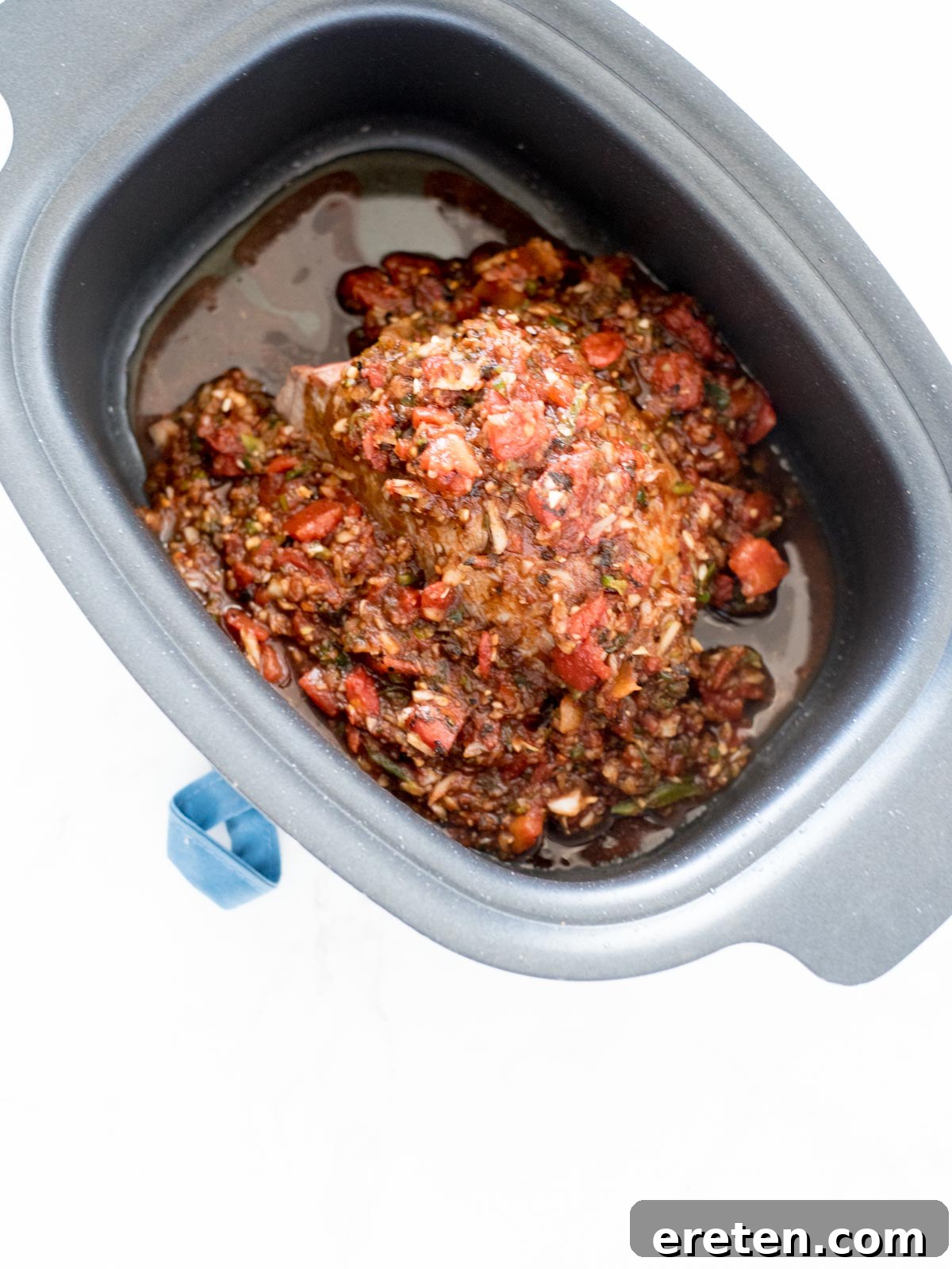 beef in crockpot with sauce poured over