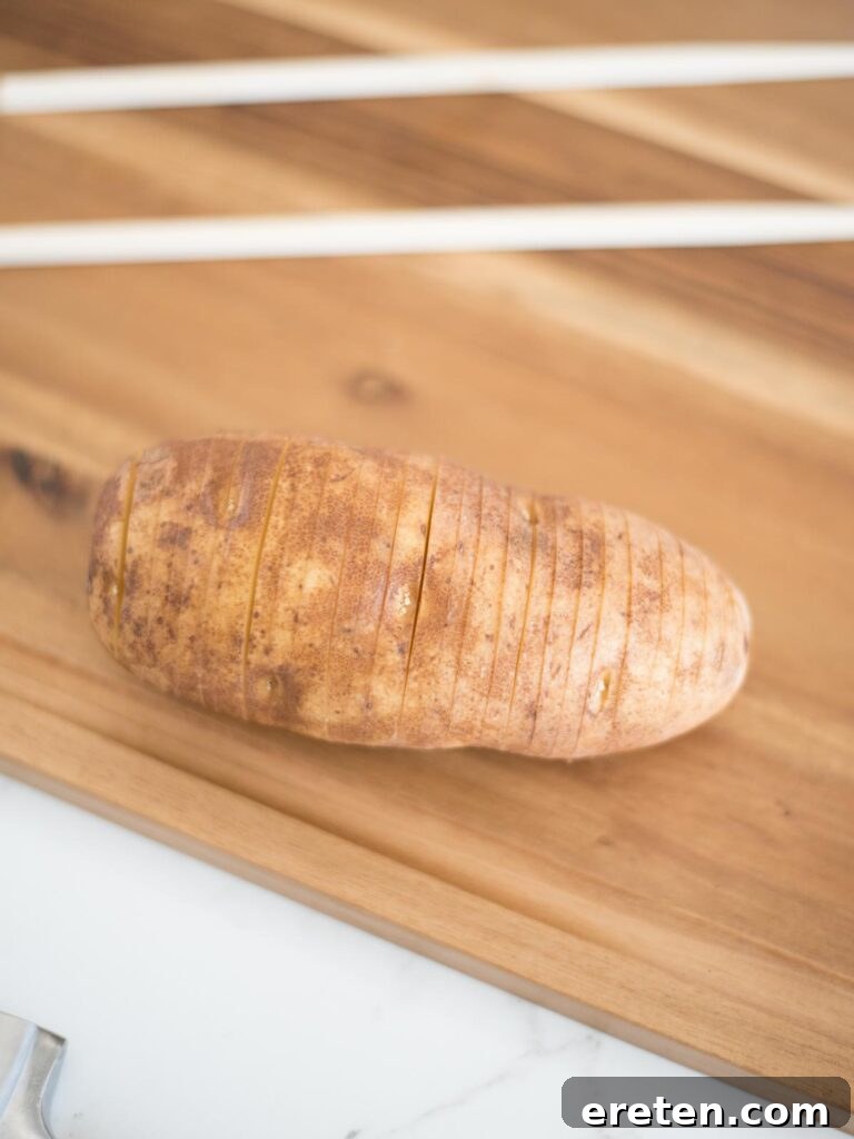 a single hasselback potato showing its distinct fanned out slices