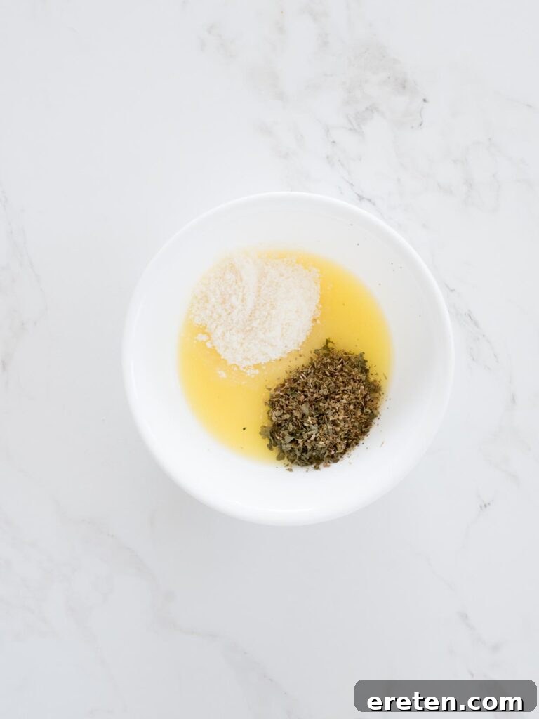 dried herbs added to butter and parmesan mixture