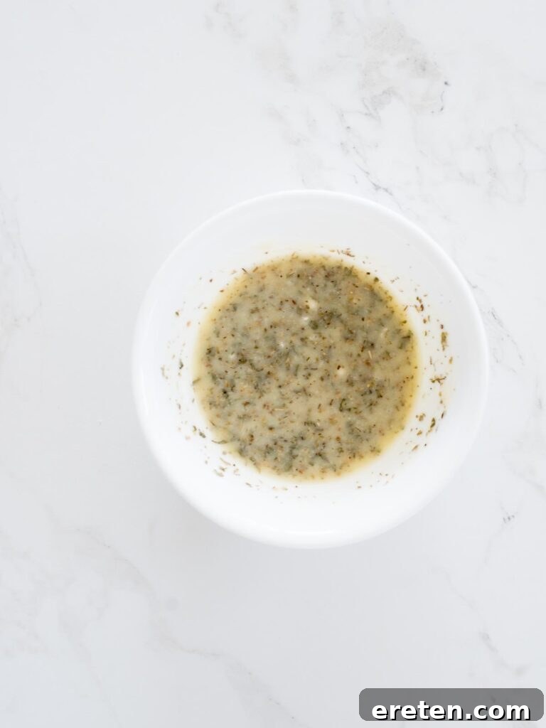 melted butter, parmesan, and herbs mixed together in a bowl