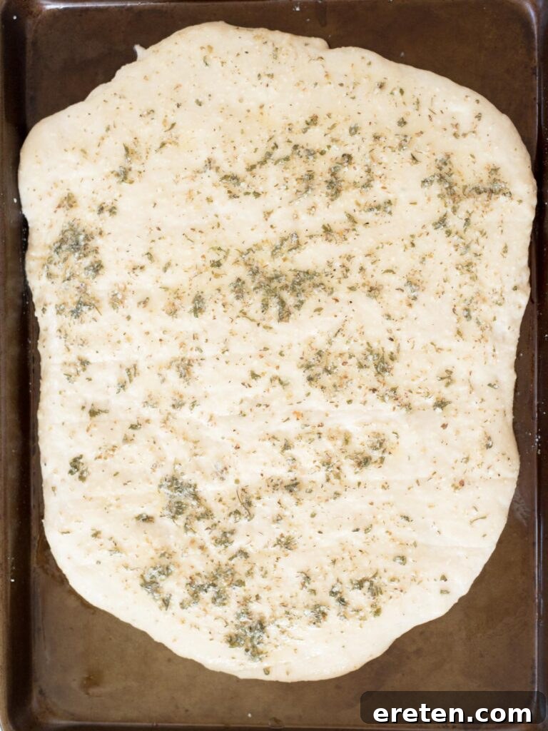 dough brushed with the garlic herb butter mixture before baking