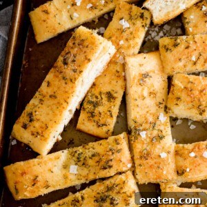 Parmesan garlic breadsticks on a platter