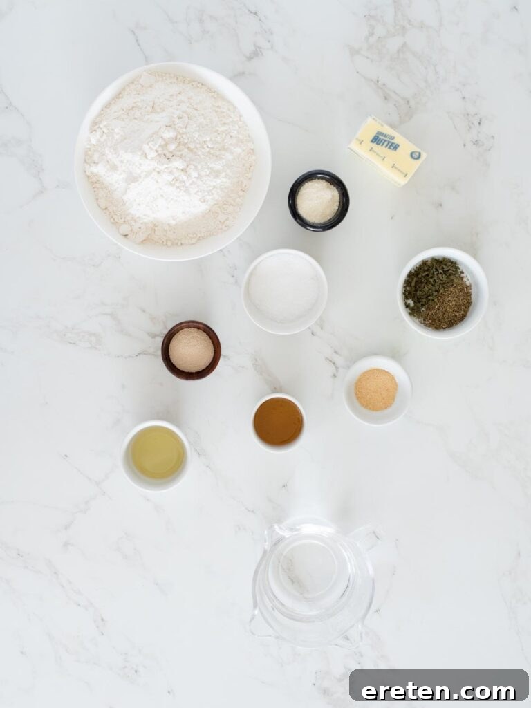 ingredients for parmesan garlic breadsticks laid out on a wooden surface