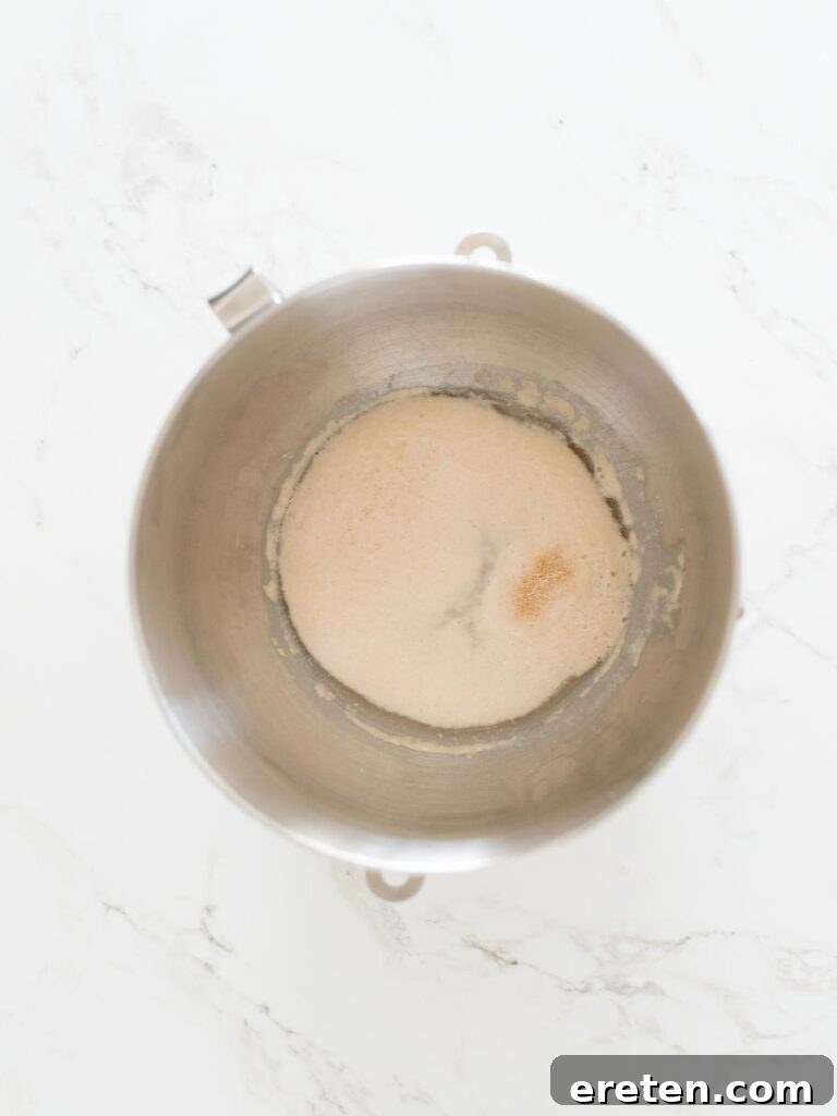 yeast, water, and honey proofing in a stand mixer bowl