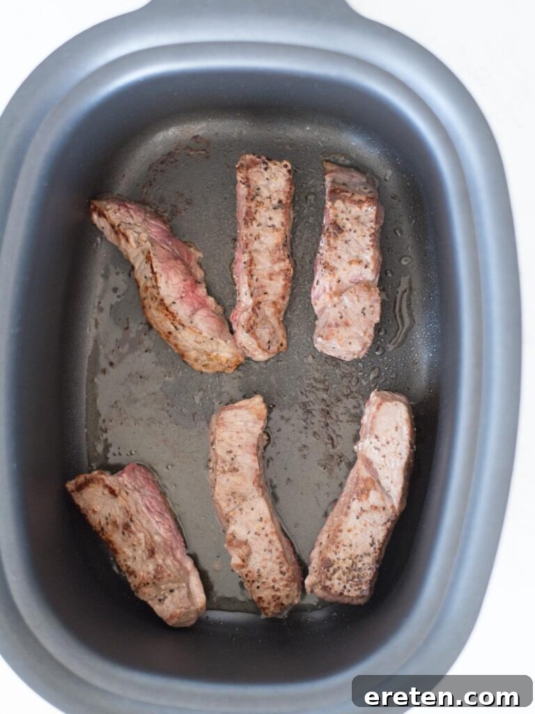 boneless beef ribs searing in pot