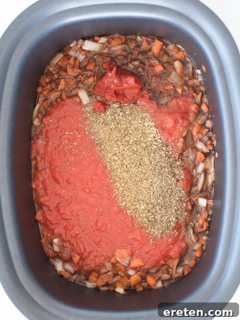 crushed tomatoes and herbs poured over vegetables