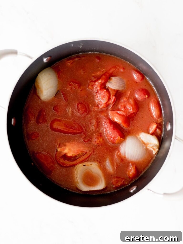 Comforting Roasted Tomato Basil Soup 6 All ingredients of roasted tomato basil soup added to the stock pot and simmering