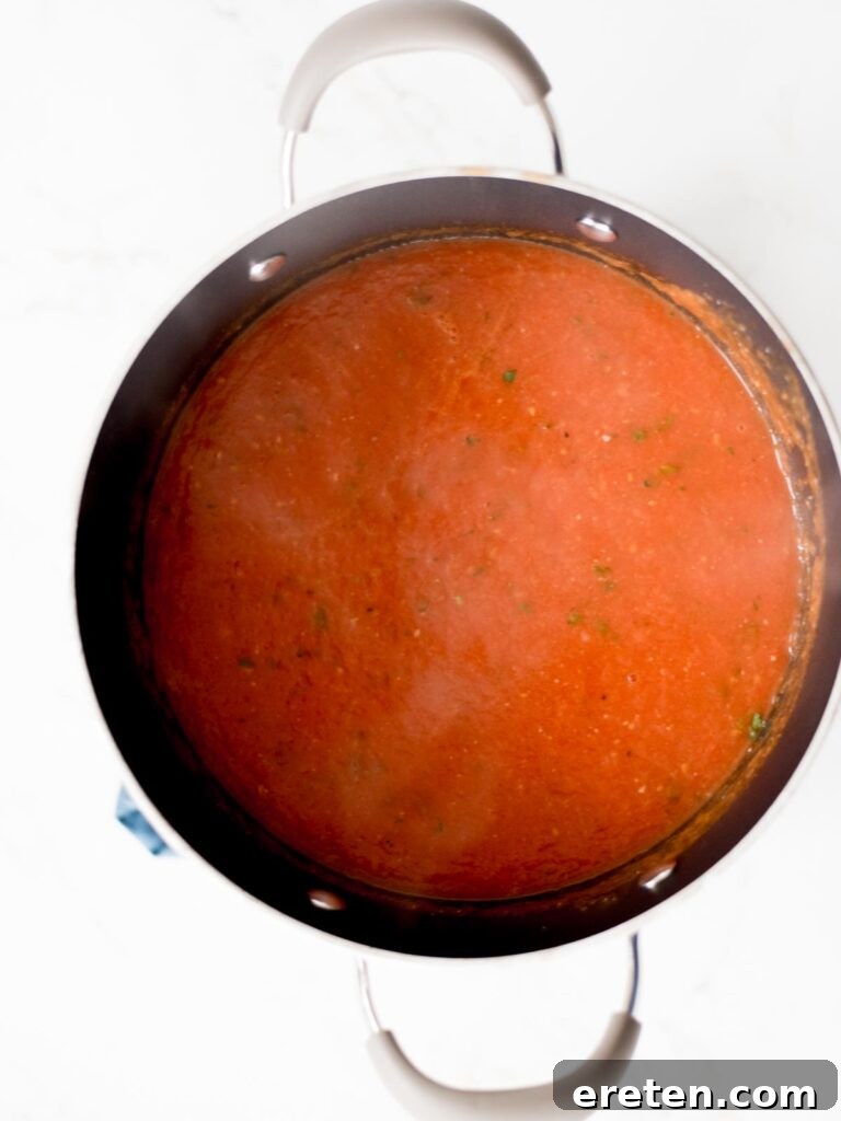 Comforting Roasted Tomato Basil Soup 7 Creamy roasted tomato basil soup after blending with an immersion blender, still in the stock pot