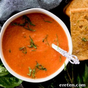 creamy roasted tomato basil soup topped with basil paired with a grilled cheese