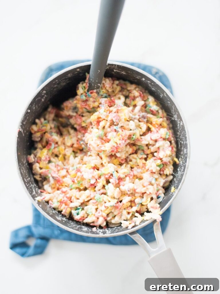 cereal mixed into the marshmallow mix in a saucepan