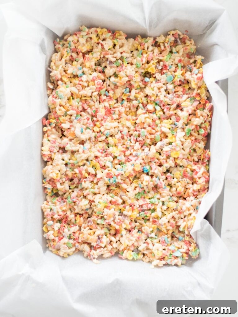 fruity pebbles rice krispie treats smoothed into a 9x13 pan