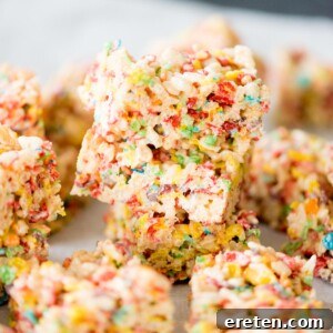 Fruity Pebbles Rice Krispie Treats stacked on top of each other