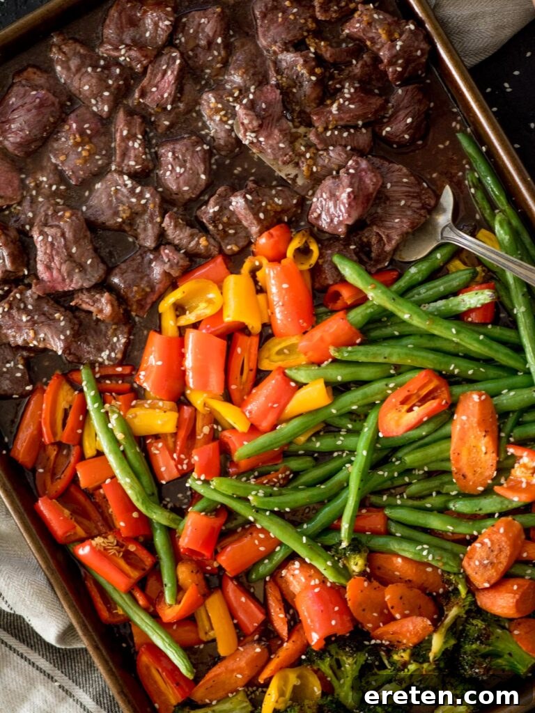 easy sheet pan beef teriyaki cooked on a baking sheet with a serving spoon
