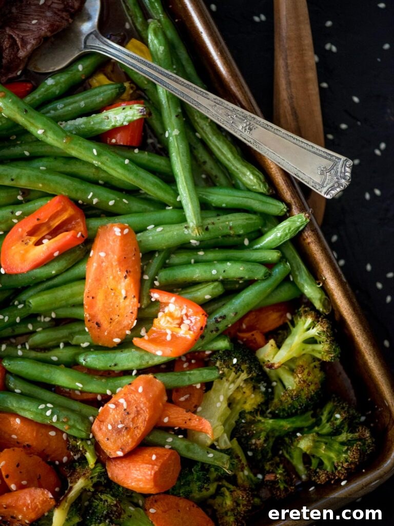 carrots, green beans and broccoli cooked on a sheet pan