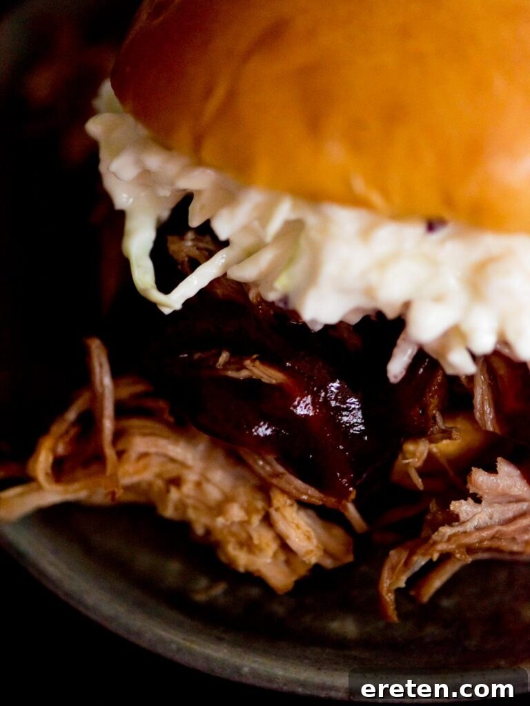 instant pot sweet pulled pork with bbq sauce and coleslaw in a brioche bun