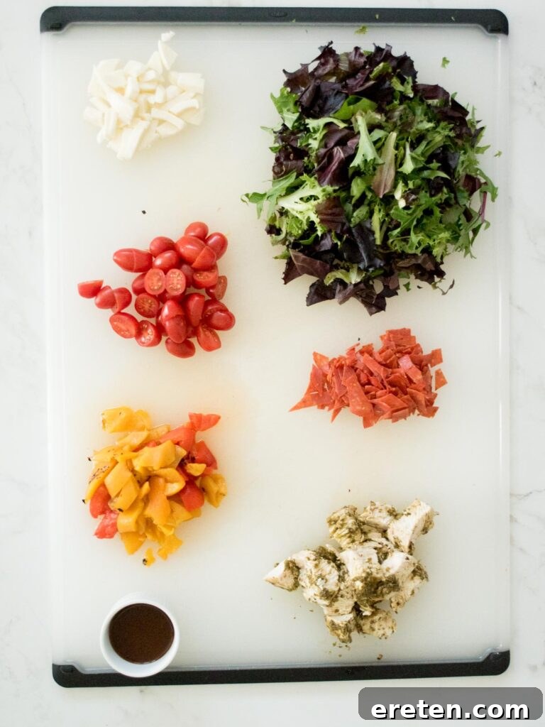 Layered Pesto Chicken Salad Jar 3 ingredients on a cutting board for pesto chicken mason jar salad
