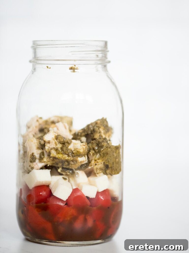 Layered Pesto Chicken Salad Jar 8 balsamic vinaigrette, roasted peppers, grape tomatoes, basil pesto chicken, and mozzarella in a jar