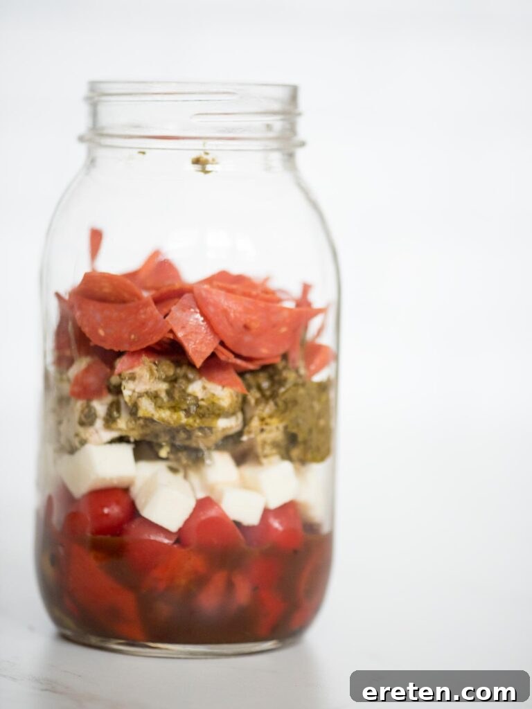 Layered Pesto Chicken Salad Jar 9 balsamic vinaigrette, roasted peppers, grape tomatoes, basil pesto chicken, pepperoni, and mozzarella in a jar
