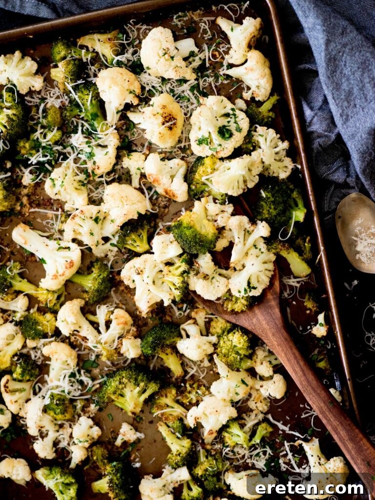Crispy garlic parmesan roasted cauliflower and broccoli on a sheet pan, ready to serve.