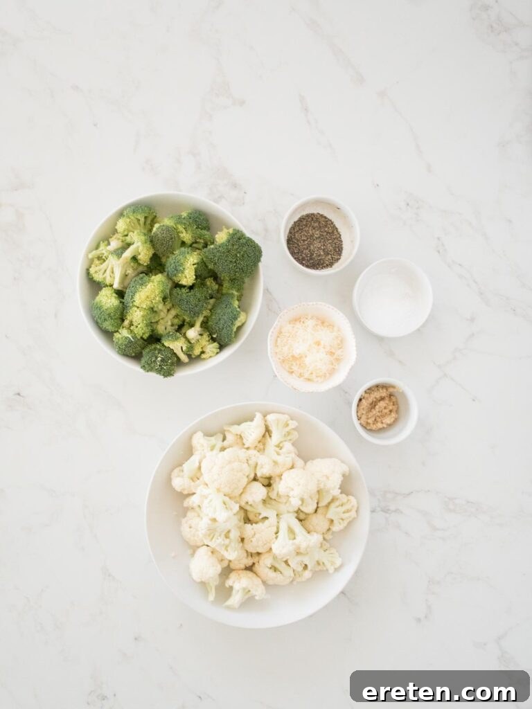 Ingredients for garlic parmesan roasted broccoli and cauliflower laid out on a kitchen counter.