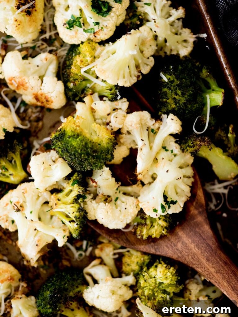 A close-up of garlic parmesan roasted cauliflower and broccoli, highlighting its golden-brown texture.