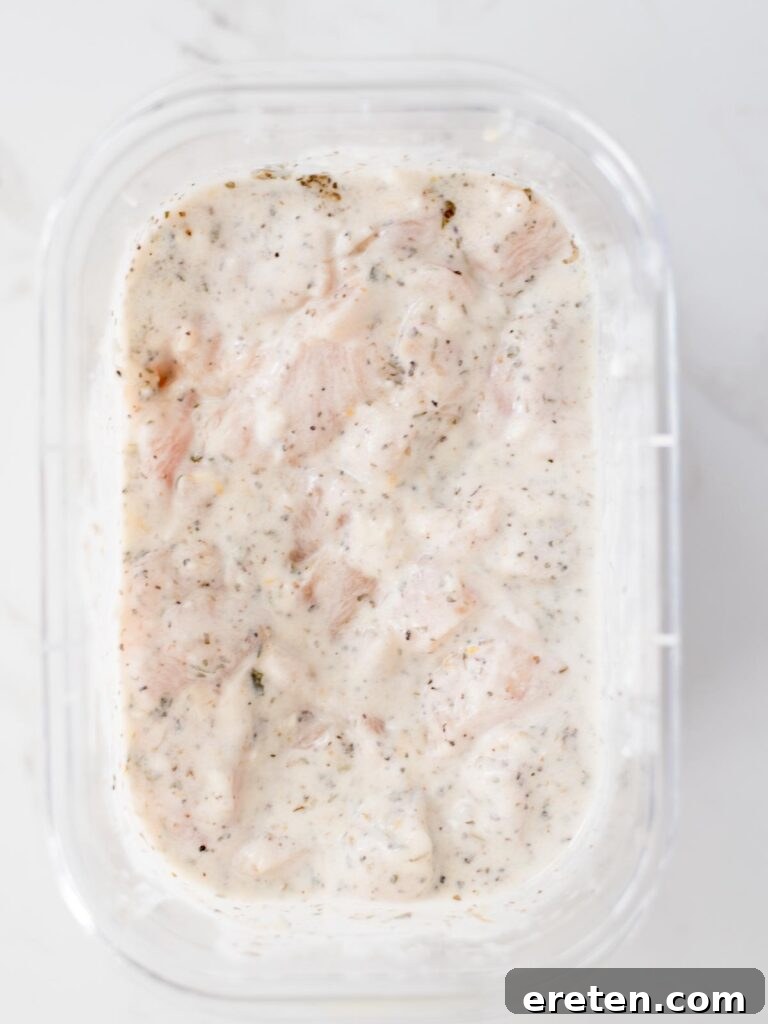 Chicken chunks fully mixed and coated with the Greek yogurt marinade.