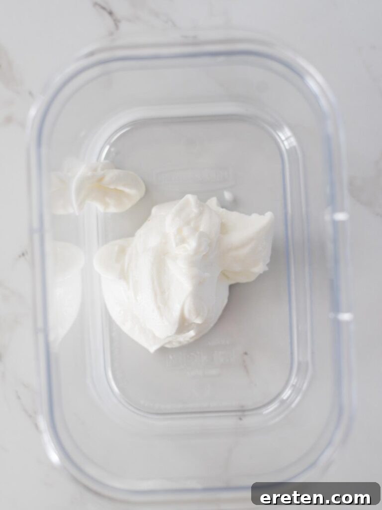 A bowl of creamy plain Greek yogurt, ready for the marinade.