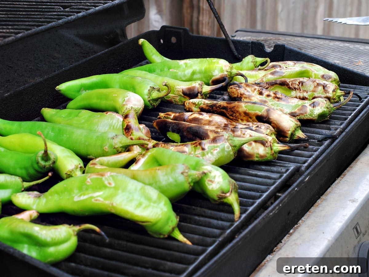Close-up of green chiles charring and blistering on a grill
