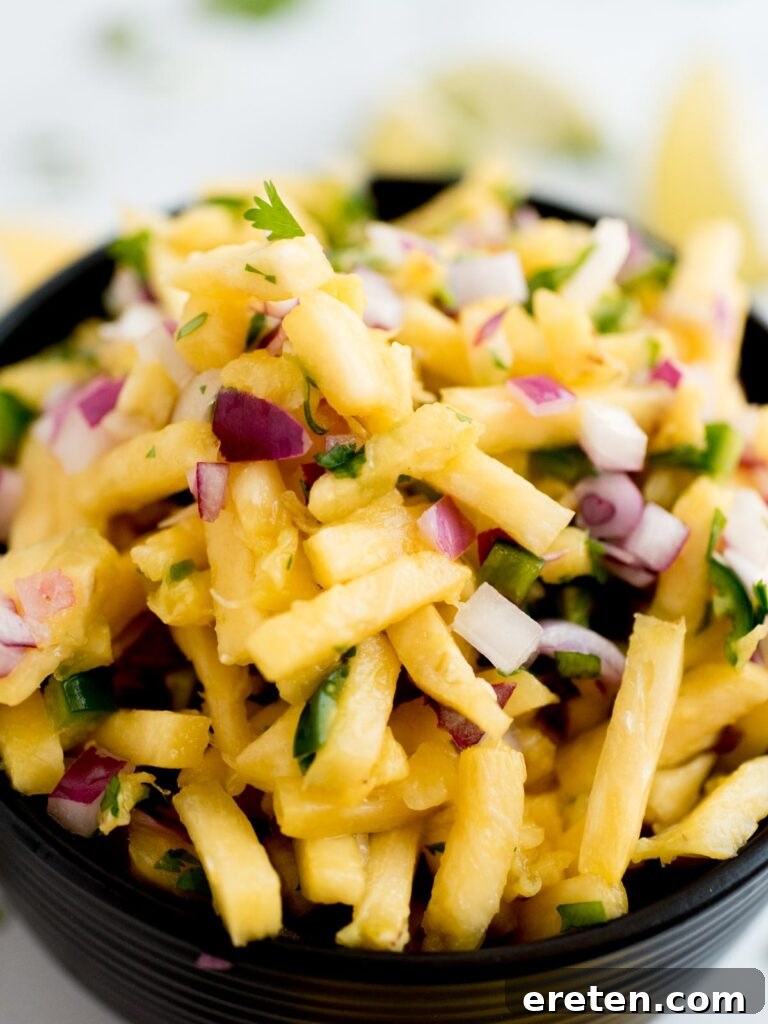 Tropical Pineapple Salsa 3 Close-up shot of pineapple pico de gallo in a black serving bowl, highlighting the colorful diced ingredients