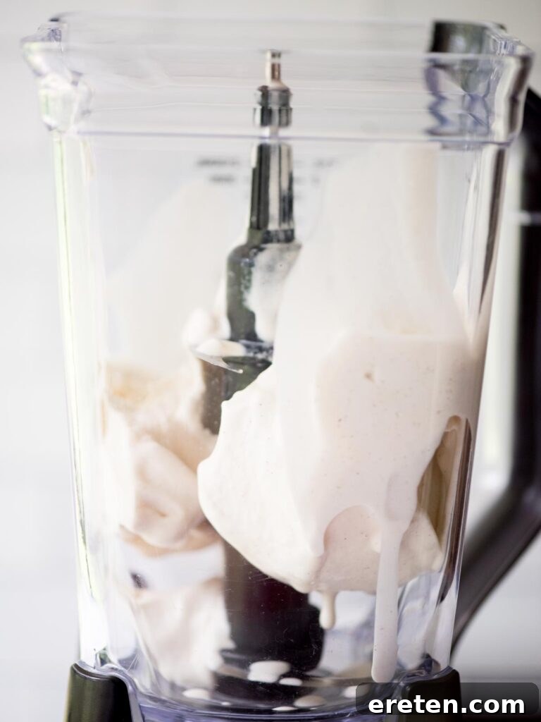 A scoop of rich vanilla ice cream ready to be blended for a creamy pumpkin milkshake.
