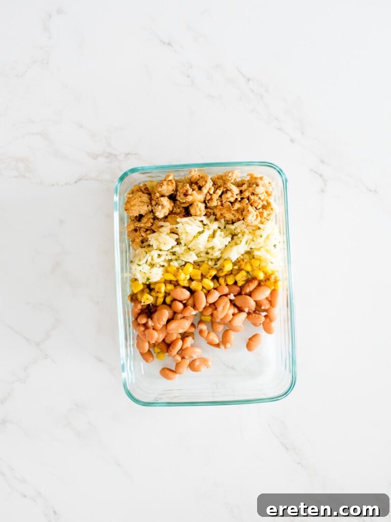 turkey, rice, corn, and beans in a glass container