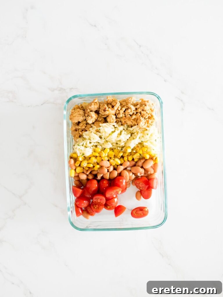 turkey, rice, corn, beans, and tomatoes added to a glass container