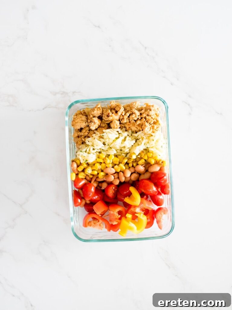 turkey, rice, corn, beans, tomatoes, and peppers added to a glass container