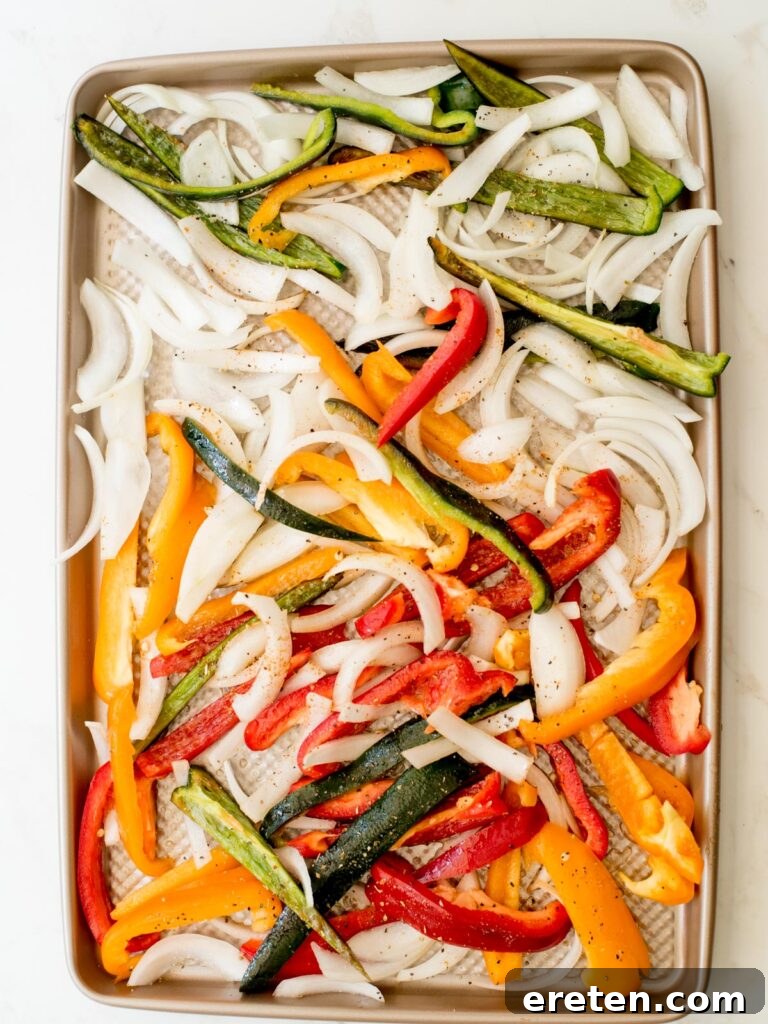 One Pan Chicken Fajita Dinner 5 seasoned vegetables on a sheet pan