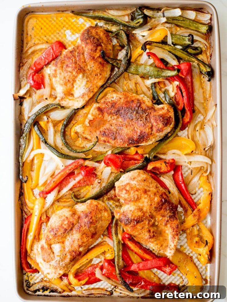 One Pan Chicken Fajita Dinner 7 cooked vegetables and chicken on a sheet pan