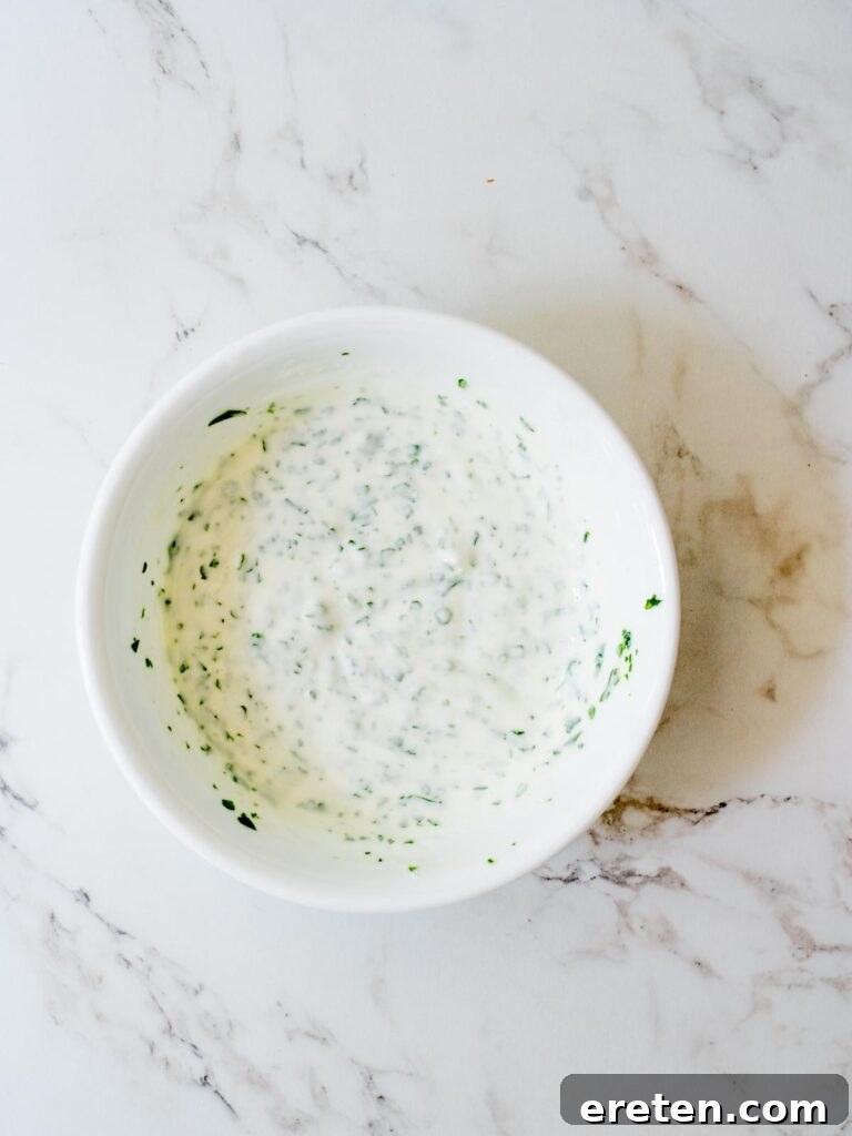One Pan Chicken Fajita Dinner 8 creamy cilantro lime sauce mixed together in a bowl