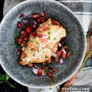 Slow Cooker Salsa Chicken with Melted Queso 9 crockpot salsa chicken with queso topped with cilantro tomatoes and red onion in a bowl