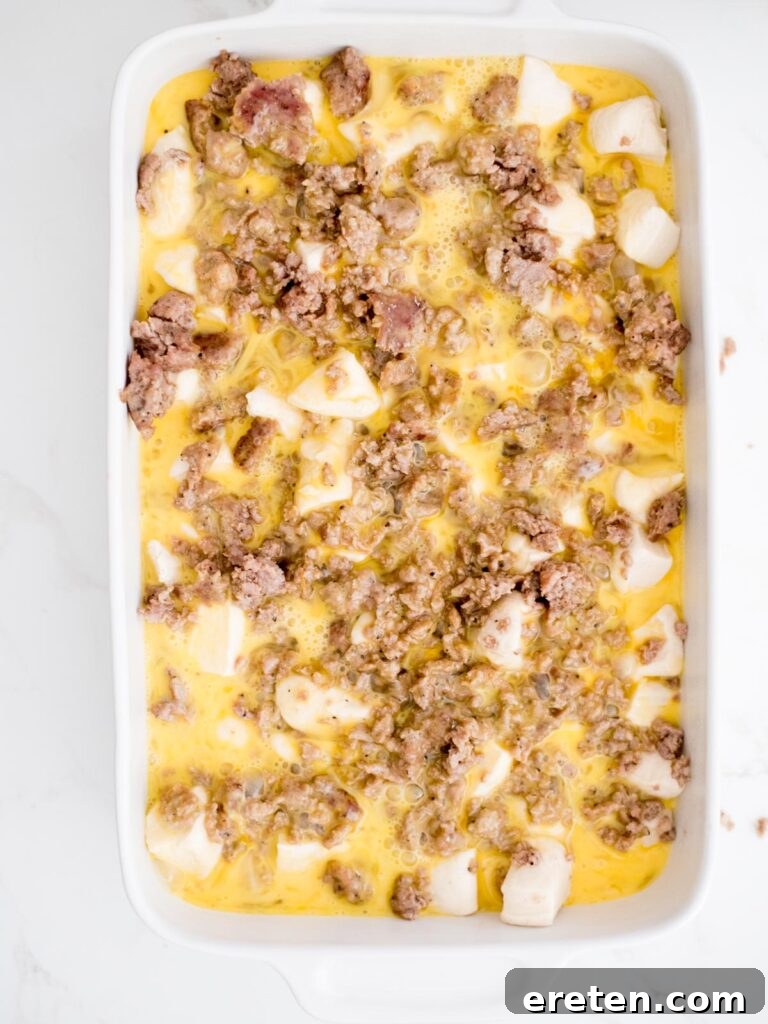 Golden Biscuit Breakfast Bake 9 eggs added to casserole dish with biscuits and sausage