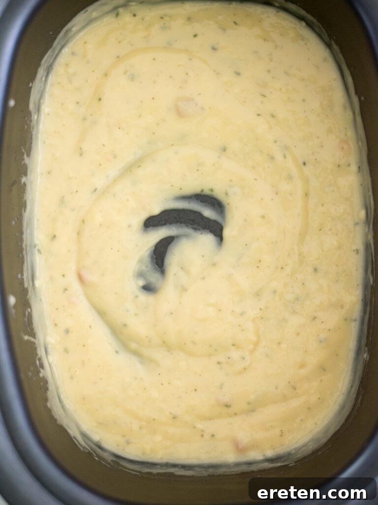 Creamy Ranch Slow Cooker Chicken 5 The ranch seasoning, cream of chicken soup, and chicken stock are mixed together thoroughly in the crockpot, forming a smooth sauce base.