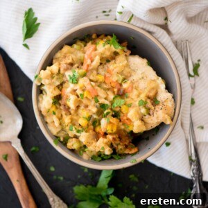 chicken and stuffing in a bowl topped with parsley