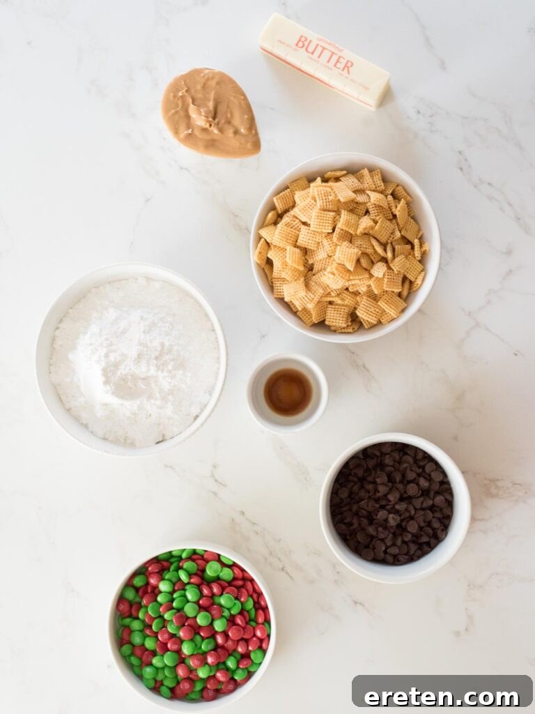 Festive Homemade Muddy Buddies 3 Ingredients laid out on a table, including Chex cereal, butter, peanut butter, chocolate chips, vanilla, powdered sugar, and holiday M&Ms, ready to make reindeer chow.