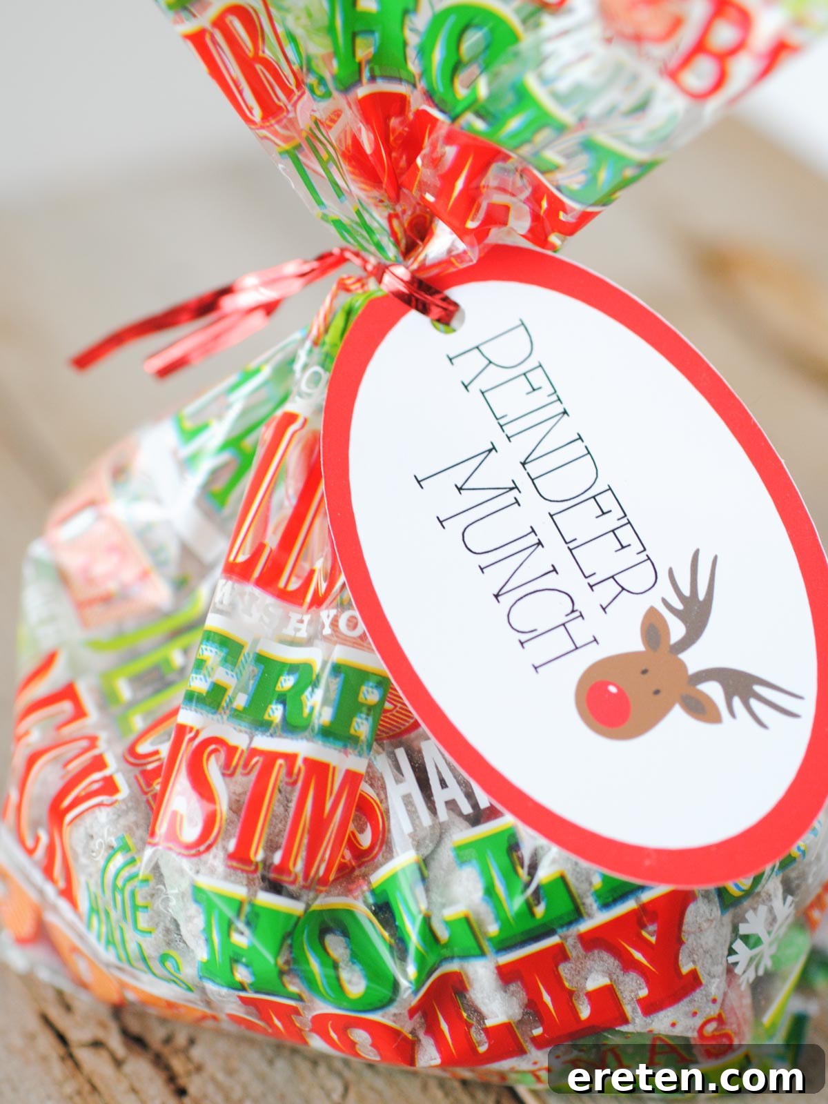Festive Homemade Muddy Buddies 9 Reindeer Munch packaged in a festive Christmas treat bag, complete with a holiday tag, perfect for gifting.